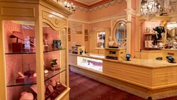 The interior of a jewelry store, with a checkout counter and jewelry displayed in glass cases
