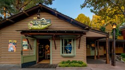 The exterior of Louis' Critter Club shop displaying a shirt in the storefront window.
