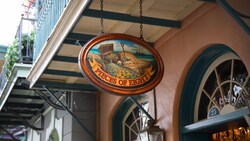 A hanging sign for Pieces of Eight at Disneyland Park featuring a painted treasure chest