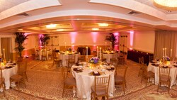 Fisheye view of banquet room with round tables set formally