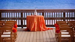Chairs and a decorated table set up on Beachside Boardwalk, overlooking the ocean