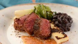Carne asada served with beans and grilled queso fresco