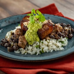 Pork belly and black beans served over a bed of white rice