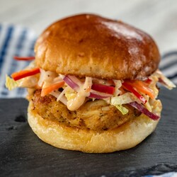 A crab cake slider topped with cole slaw