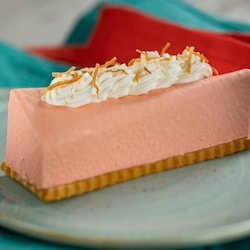 A sugar cookie topped with guava mousse and whipped cream