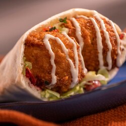 A pita pocket filled with falafel that’s drizzled with tahini sauce EPCOT International Food and Wine Festival 