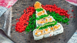 Pieces of sushi arranged in the shape of a Christmas tree