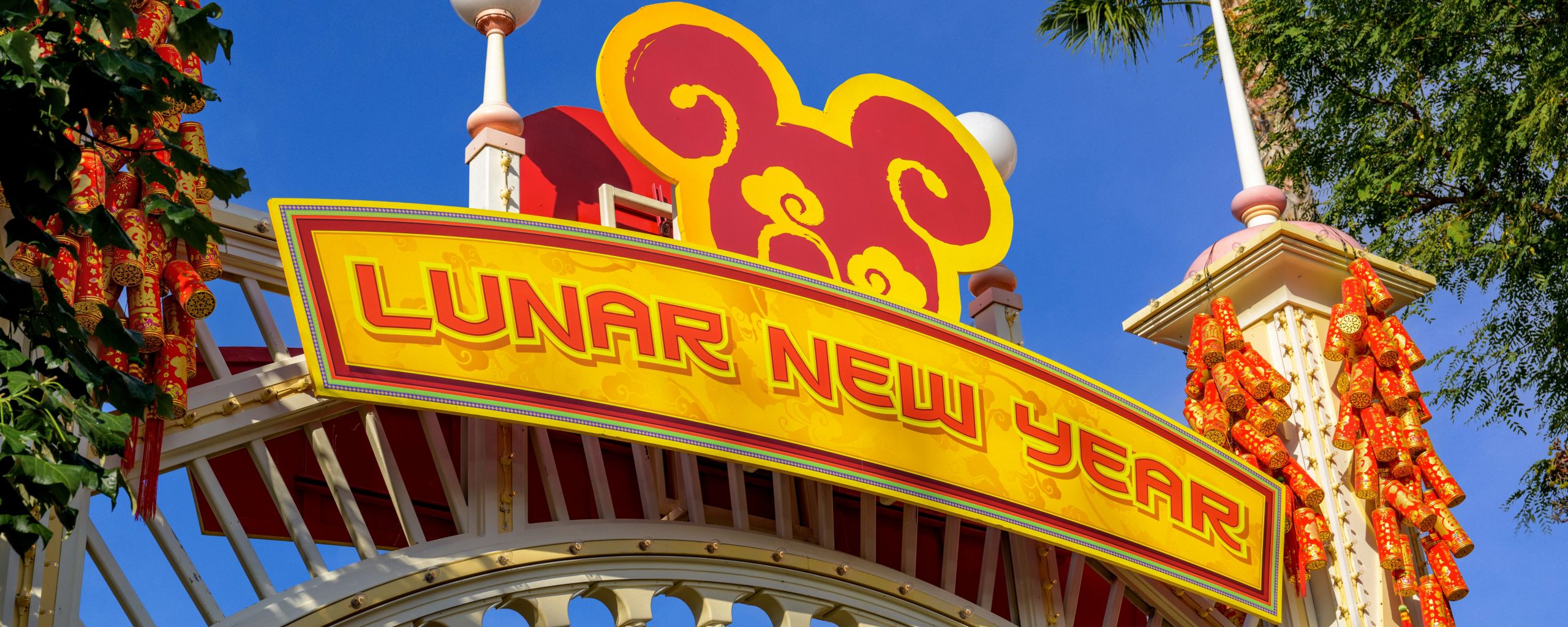 A sign reading Lunar New Year, featuring a Mickey Mouse logo