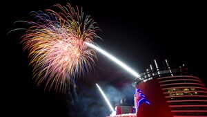 Brilliant fireworks light up the night sky above a Disney Cruise Line ship 