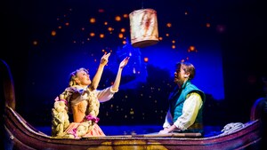 Sitting in a small boat, Rapunzel and Flynn watch the lantern that is between them float up into the night sky, which is filled with many more glowing lanterns