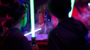 A stage show at night with Darth Vader ready for battle