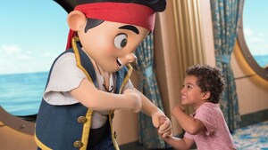 A smiling young boy meets Jake the Neverland pirate