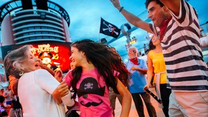 Guests dancing and reveling at a pirate party on the deck of a Disney Cruise Line ship