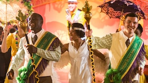 The Princess Tiana Character and other costumed performers with props engaged in a New Orleans style celebration