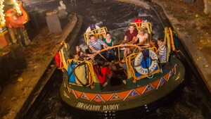 Guests of all ages holding on tightly while riding Kali River Rapids at Disney’s Animal Kingdom park