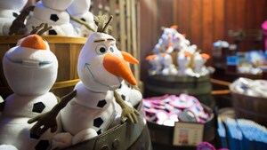 Olaf plush dolls fill merchandise barrels inside the Wandering Reindeer shop at the Norway Pavilion