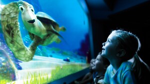 A young female Guest smiling excitedly while she experiences Turtle Talk with Crush in Future World