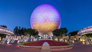 Monorails pass by both sides of Spaceship Earth as the iconic centerpiece of Epcot lights up at night