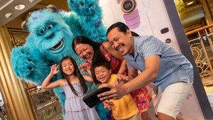 A family taking a selfie with Sulley from the Pixar film Monsters Inc