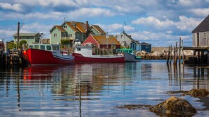 3 fishing boats moored in a typical Canadian fishing village harbor