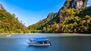 A calm bay with boats surrounded by jungle covered cliffs in Singapore