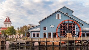 Disney’s Port Orleans Resort Riverside, a farm style building with a large water wheel and a wooden bridge, by the banks of the Sassagoula River