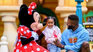 Father and daughter meet Minnie at the Disneyland Resort