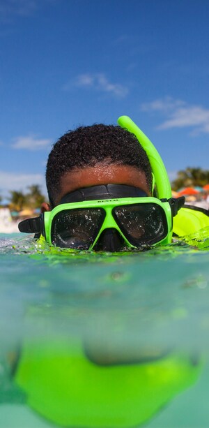 A young boy snorkeling in the water