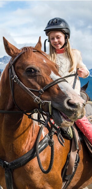 A young girl riding a horse