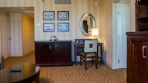 Living room has coffee table, entertainment centre, dresser and desk with chair