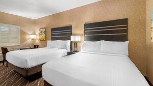 A standard hotel room with two queen beds at Best Western Plus Park Place Inn Mini Suites