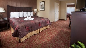A king sized bed in a Family Suite at Castle Inn & Suites