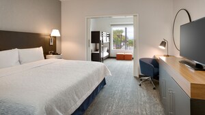 A Kids King Suite with a king bed and living area at the Hampton Inn & Suites by Hilton Anaheim Resort Convention Center