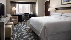 A hotel room with a king sized bed