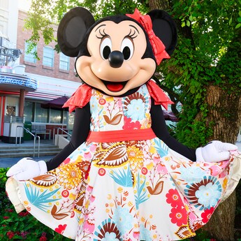Minnie Mouse strikes a pose in front of Hollywood and Vine wearing a spring dress