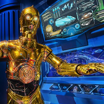C-3PO stands near a computer screen showing the schematics of a Starspeeder 1000 spacecraft