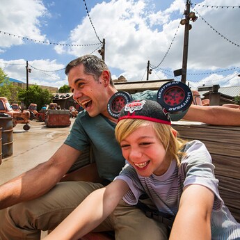 A father and son hold on as their Maters Junkyard Jamboree tractor swings
