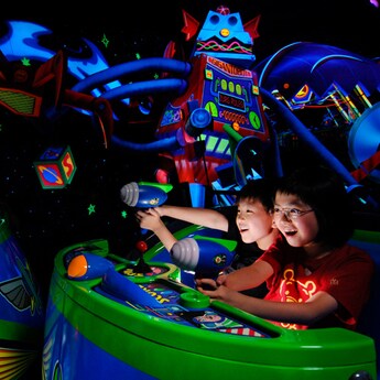 Kids shoot lasers at Zurg's evil robots on Buzz Lightyear Astro Blasters
