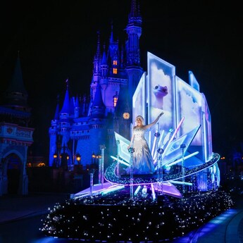 A scene from the Disney Starlight Dream the Night Away nighttime parade at Magic Kingdom park featuring Elsa from Disney’s Frozen 