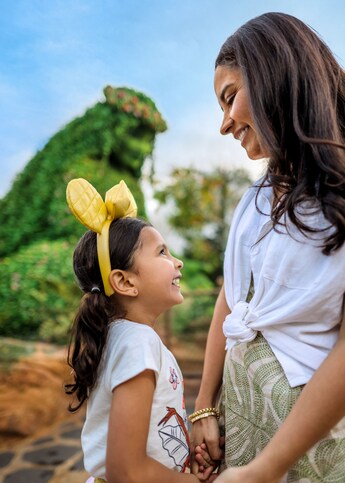A mother and daughter smiling at each other near Te Fiti