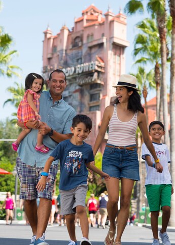 A family of 5 walking and laughing in front of the Twilight Zone Tower of Terror at Disney's Hollywood Studios