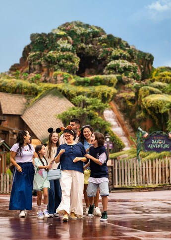 A family posing at Tiana’s Bayou Adventure in Frontierland