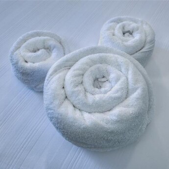 A set of towels arranged in the shape of the head and ears of Mickey Mouse