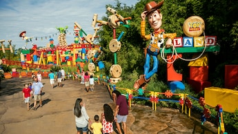 People stand near the entrance of Toy Story Land