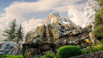 The icy mountain of Matterhorn Bobsleds, featuring a waterfall and a rickety fence along its track