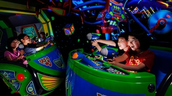 Kids shoot lasers at Zurg's evil robots on Buzz Lightyear Astro Blasters