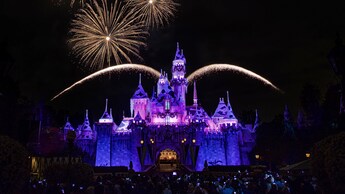 Fireworks burst over Sleeping Beauty Castle at Disneyland Park during the Believe in Holiday Magic nighttime spectacular