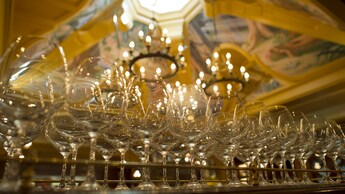 Two long rows of empty wine glasses on the Carthay Circle Restaurant bar