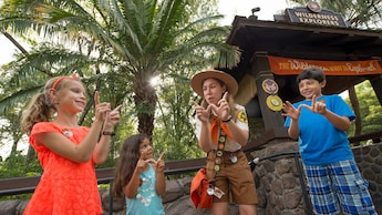 A Wilderness Explorer Troop Leader teaches children a special hand signal