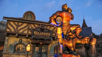 A fountain depicting Gaston and LeFou in front of Gastons Tavern